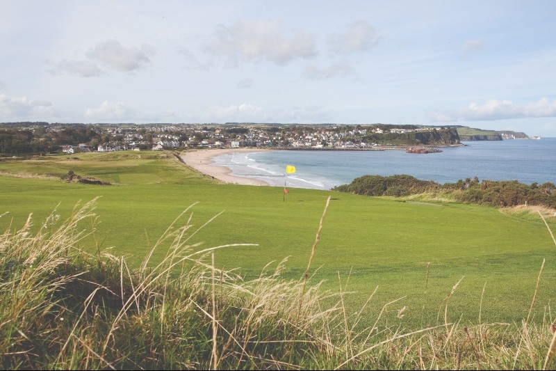 Ballycastle Golf Club in County Antrim, sweeping views across sandy shores, rugged cliffs, and the Atlantic coast.