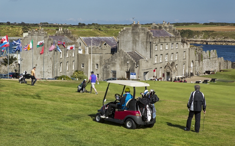Ardglass Castle overlooks the course, flags waving as golfers play where history and sport meet by the sea.