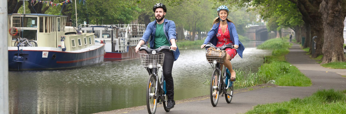 Couple cycling along a canal
