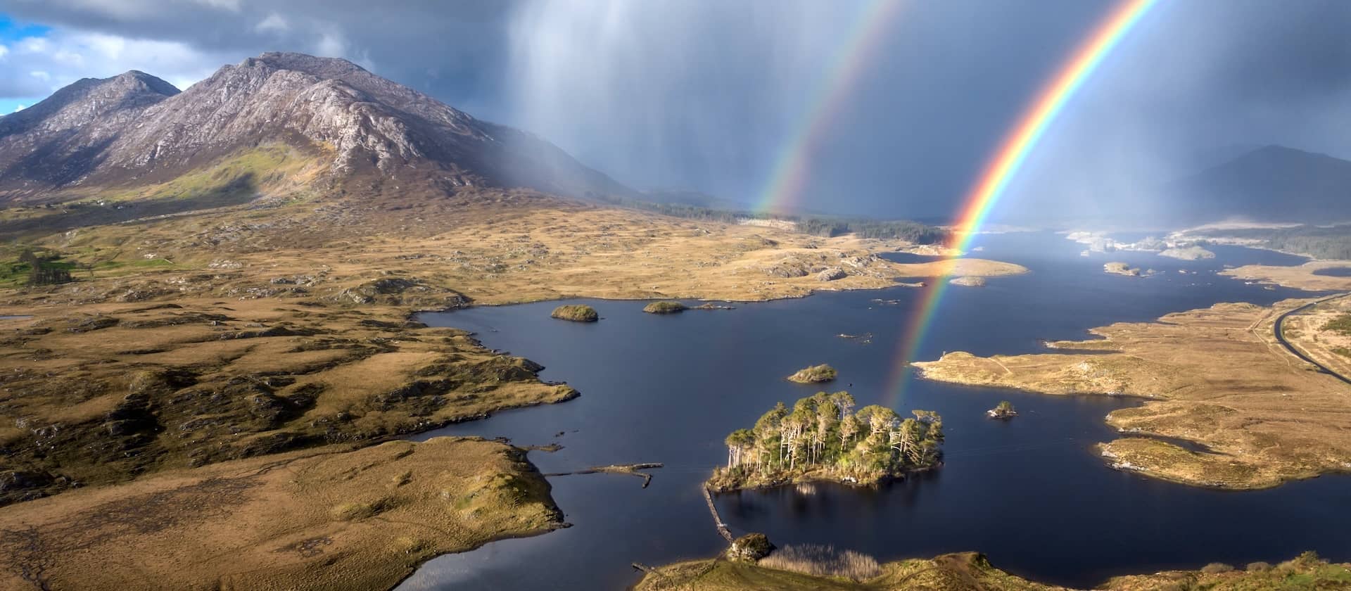 Double rainbow over Derryclare Lake and the rugged mountains of Connemara, Ireland.