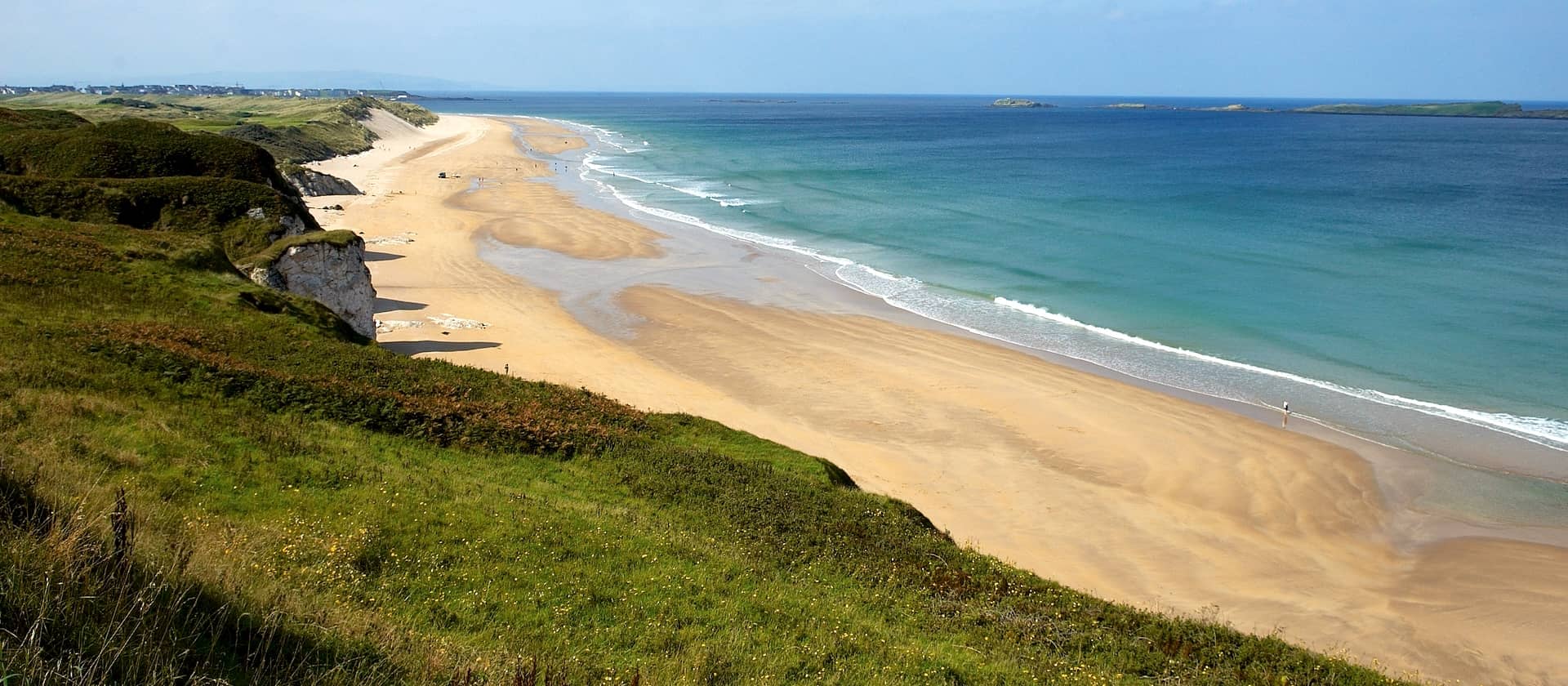 Panoramic view of Whiterocks Beach and golden sands on the Causeway Coast, County Antrim.