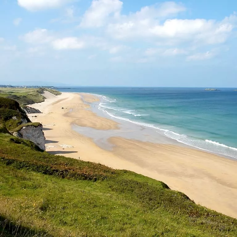 Panoramic view of Whiterocks Beach and golden sands on the Causeway Coast, County Antrim.