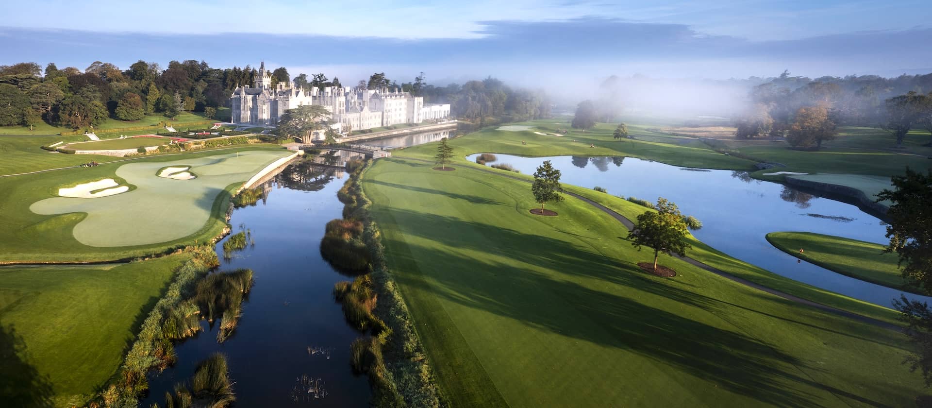 Adare Manor golf course in Limerick, Ireland, featuring manicured greens, lakes and the luxury manor hotel.