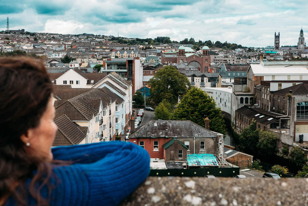 Visitor at Elizabeth Fort looking over Cork city rooftops.