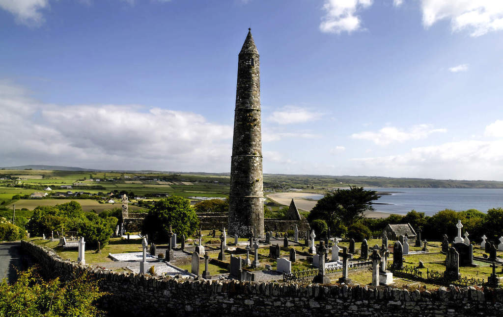 Round tower and historic graveyard overlooking the sea at Ardmore, County Waterford.