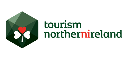 Tourism Northern Ireland logo featuring a green hexagon with a red heart and white shamrock.