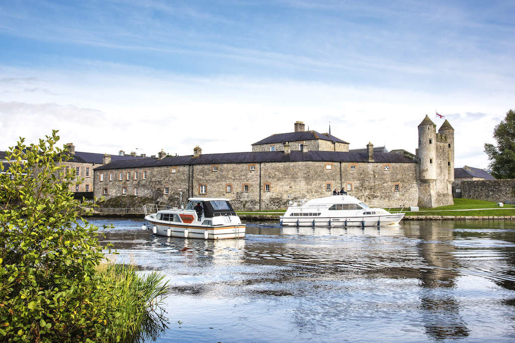 Boats moored on the River Erne beside historic Enniskillen Castle in County Fermanagh.
