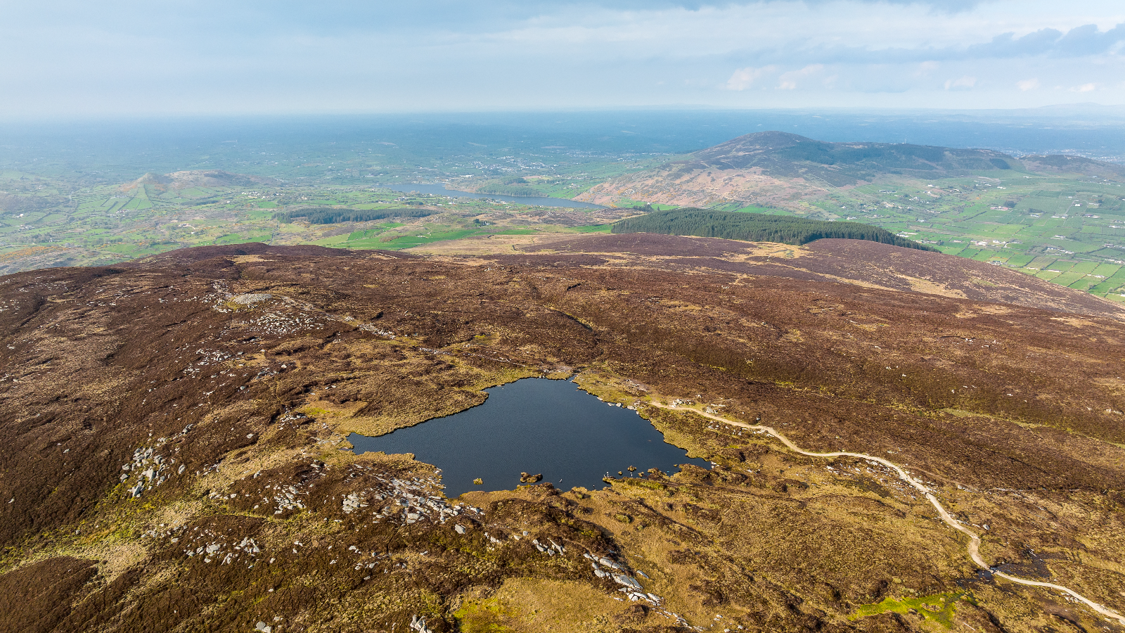 Aerial view of Slieve Gullion’s hills and mountain lake overlooking County Armagh.