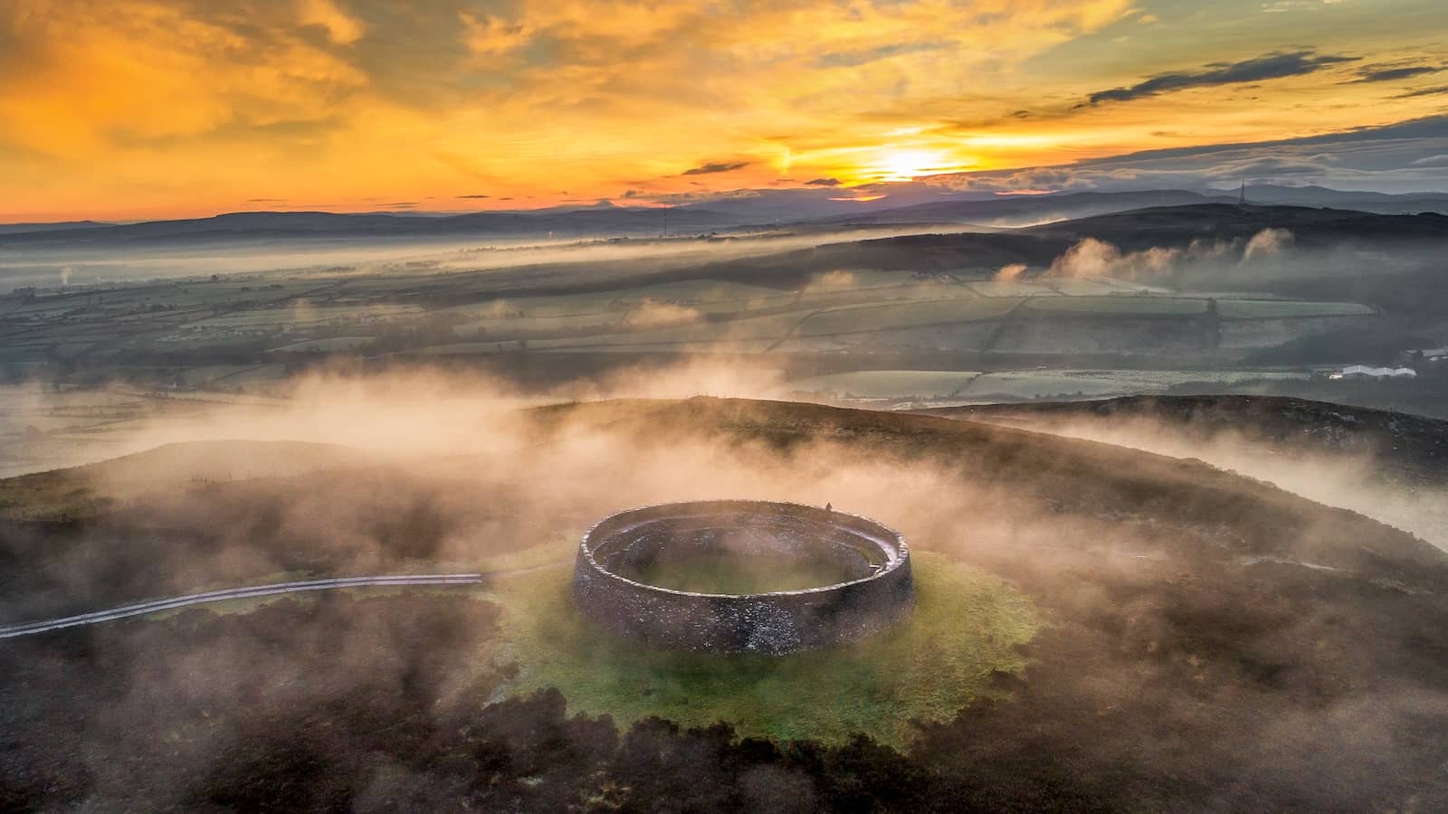 Grianán of Aileach ring fort surrounded by mist at sunrise in County Donegal.