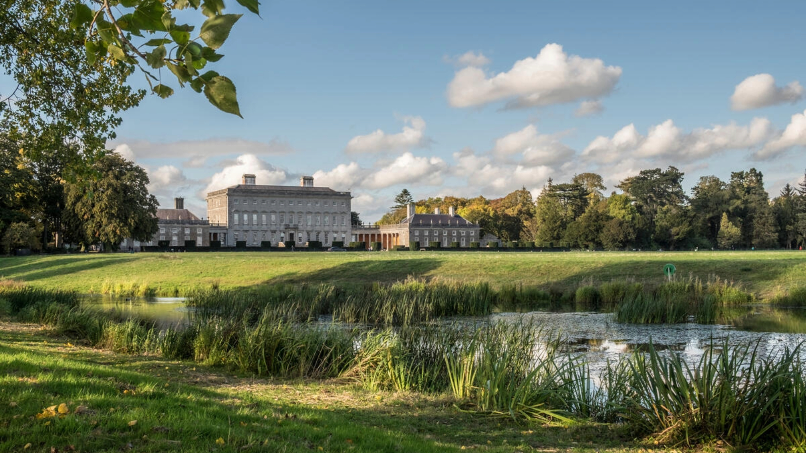 Castletown House reflected in a lake within the parkland estate at Celbridge, County Kildare.