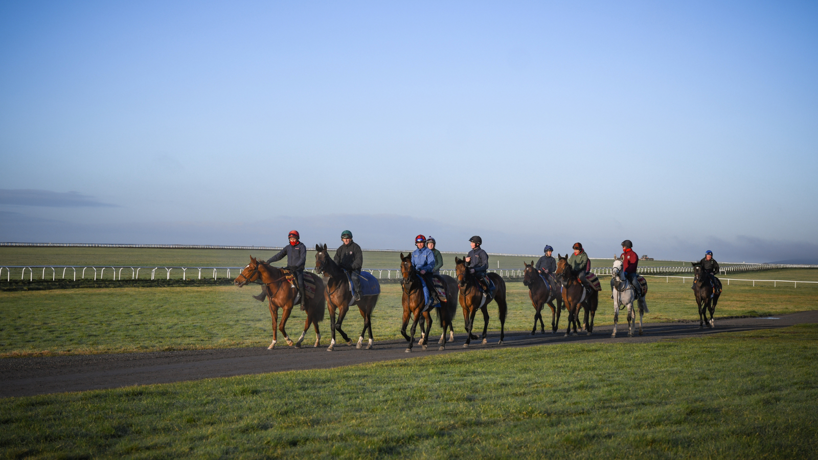 Racehorses and riders exercise on the Curragh training grounds in County Kildare.