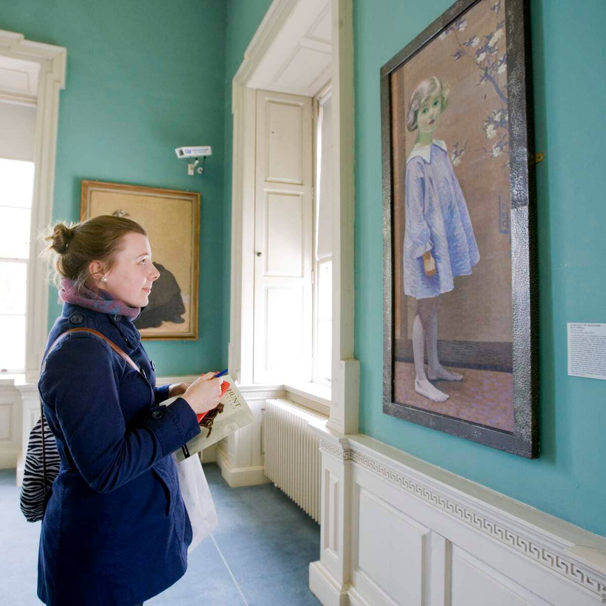 Visitor viewing artwork inside The Hunt Museum, Limerick city.