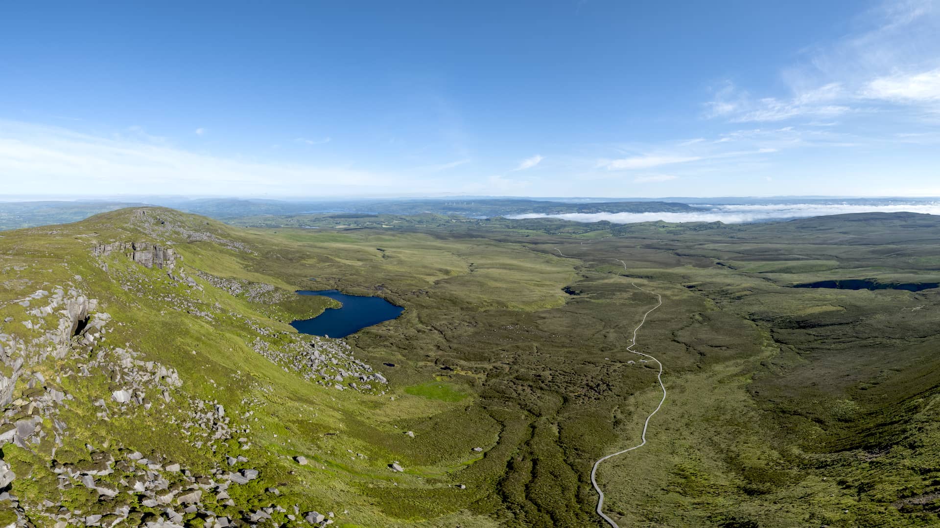 Cuilcagh Boardwalk Trail in County Fermanagh, Ireland, with mountain views and a winding wooden path.