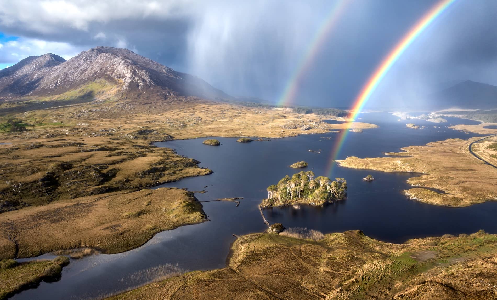 Double rainbow over Pine Island and the rugged lakes and mountains of Connemara, County Galway.