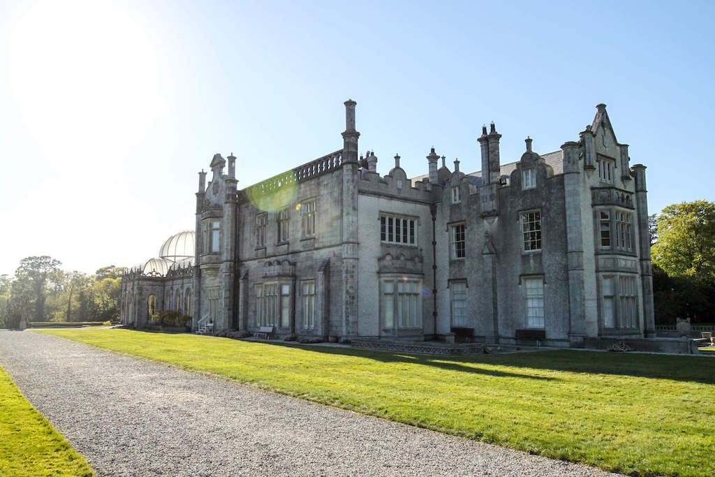 Exterior of Killruddery House, a stately home with gardens and glass dome, under bright sunlight in Wicklow.