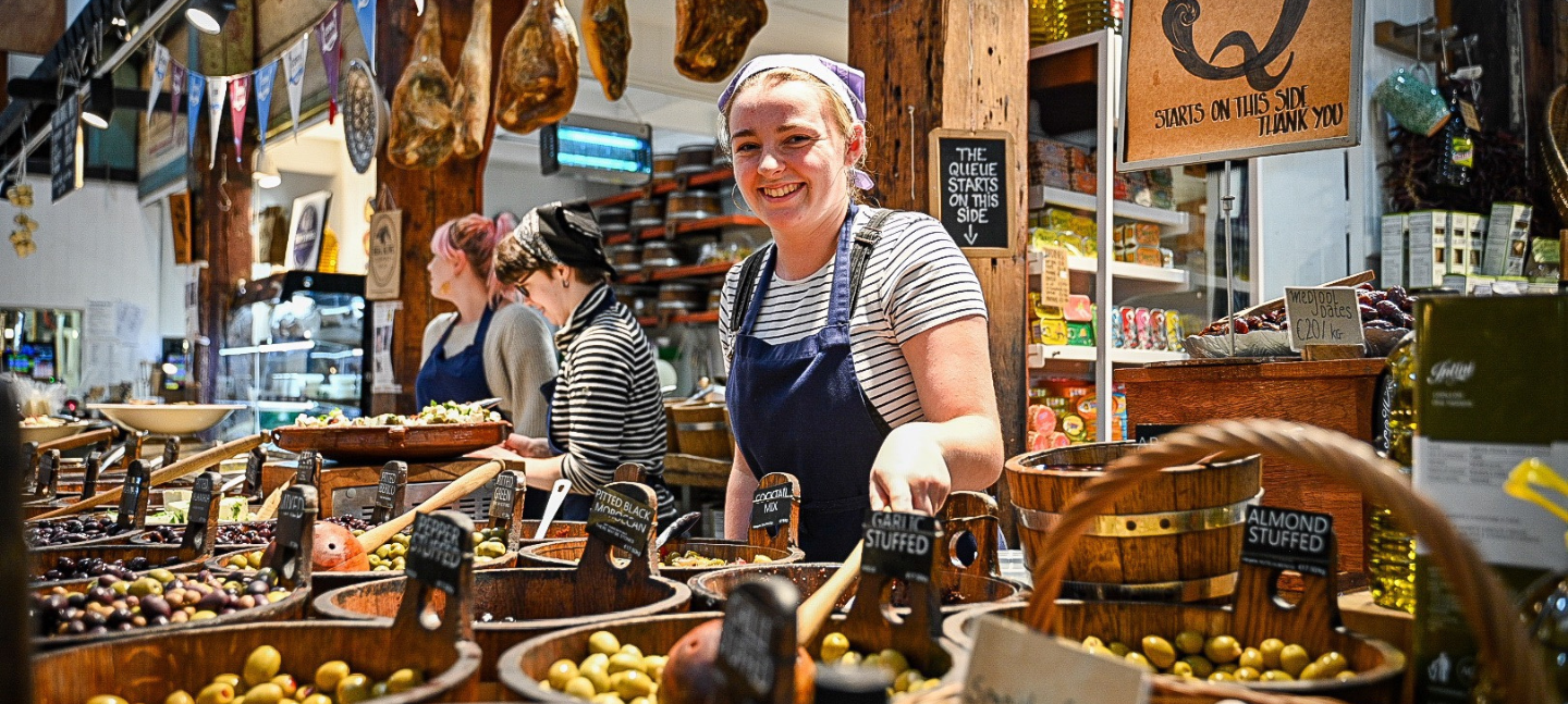 A girl working at a food market stall