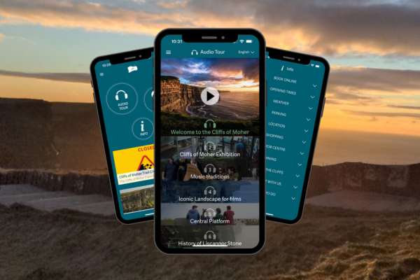An image of an audioguide app on a phone against a landscape