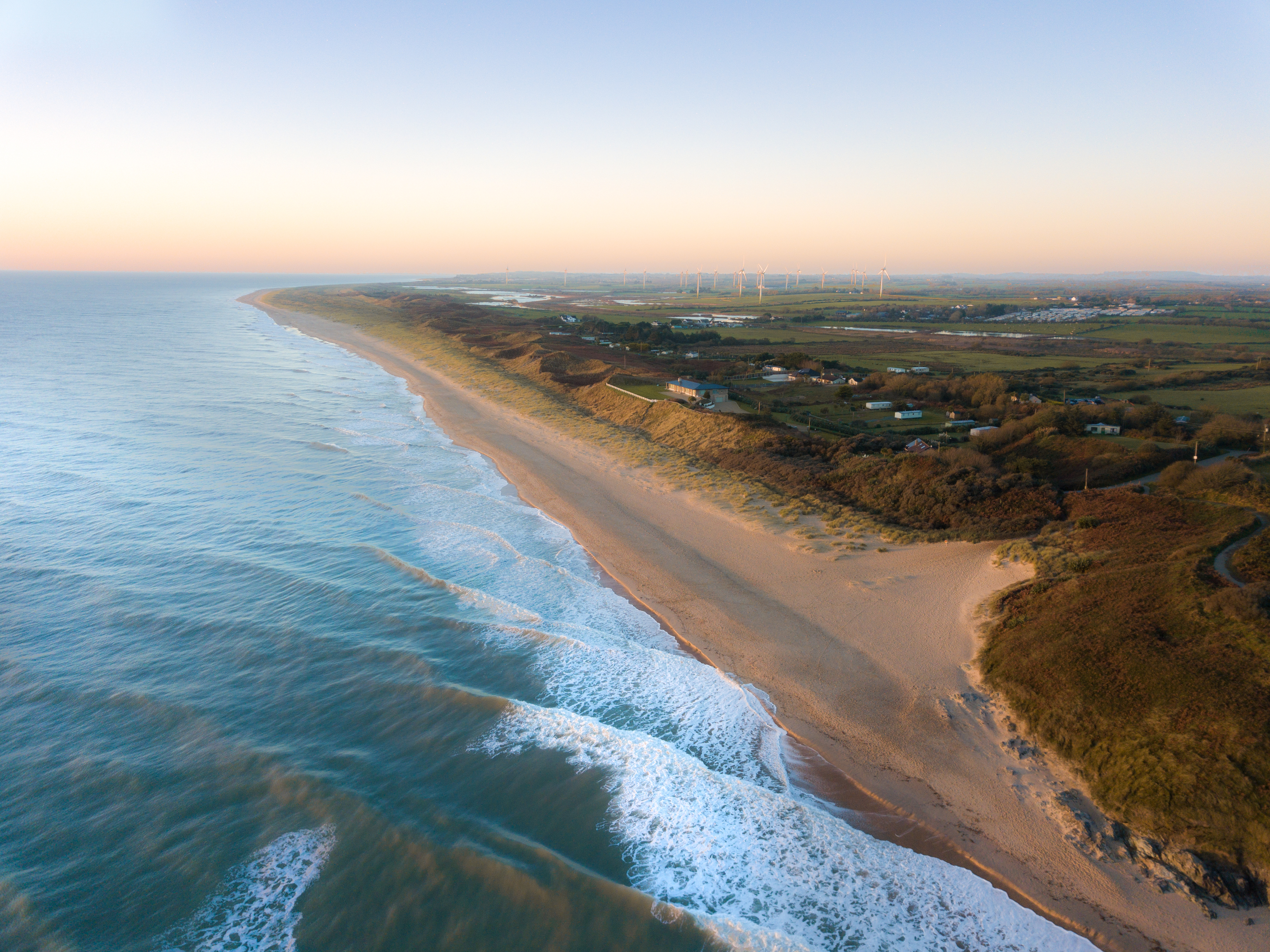 Drone shot of a beach during sunrise