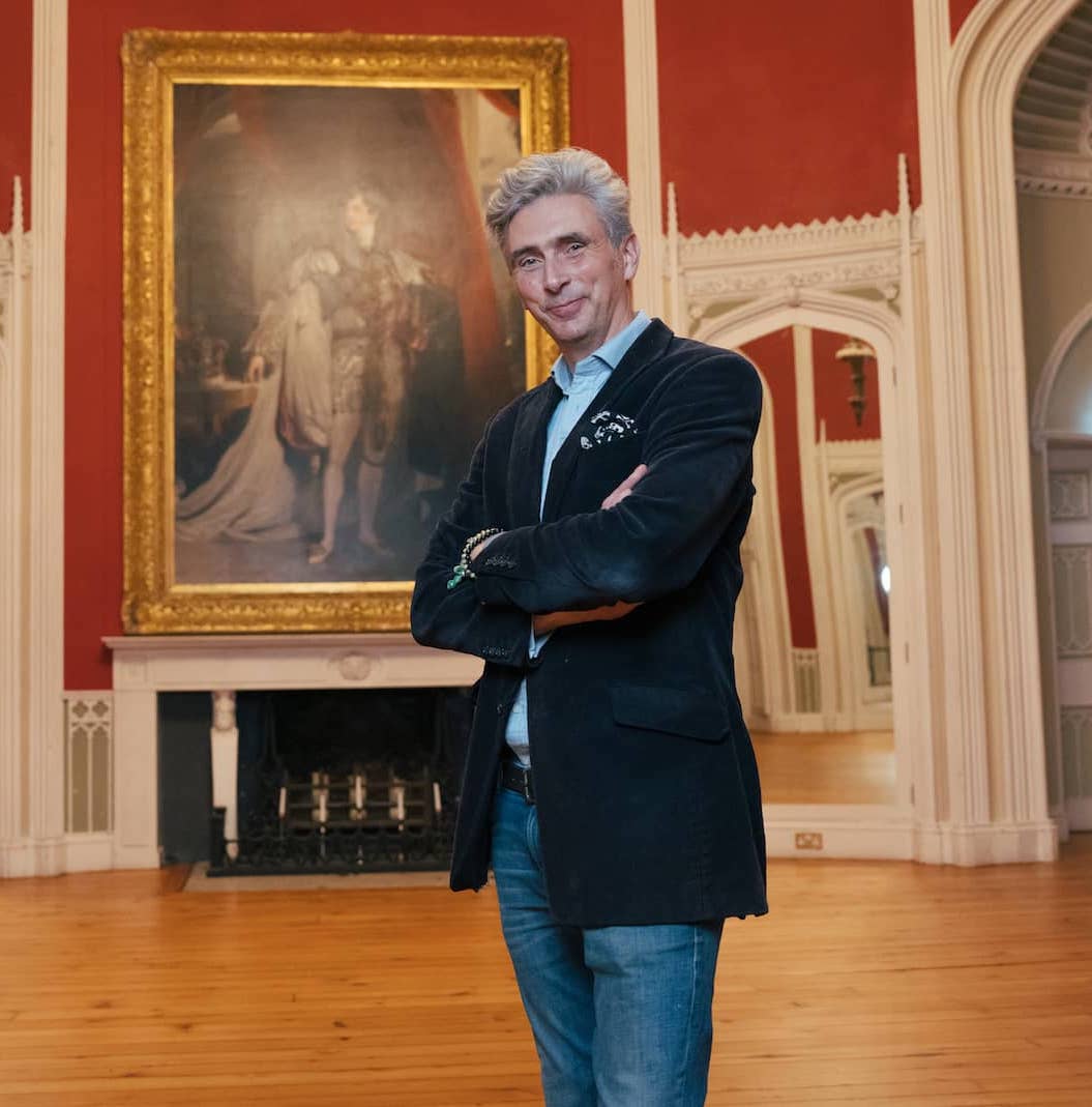 Man standing proudly inside a richly decorated Georgian room in historic Slane Castle in County Meath.