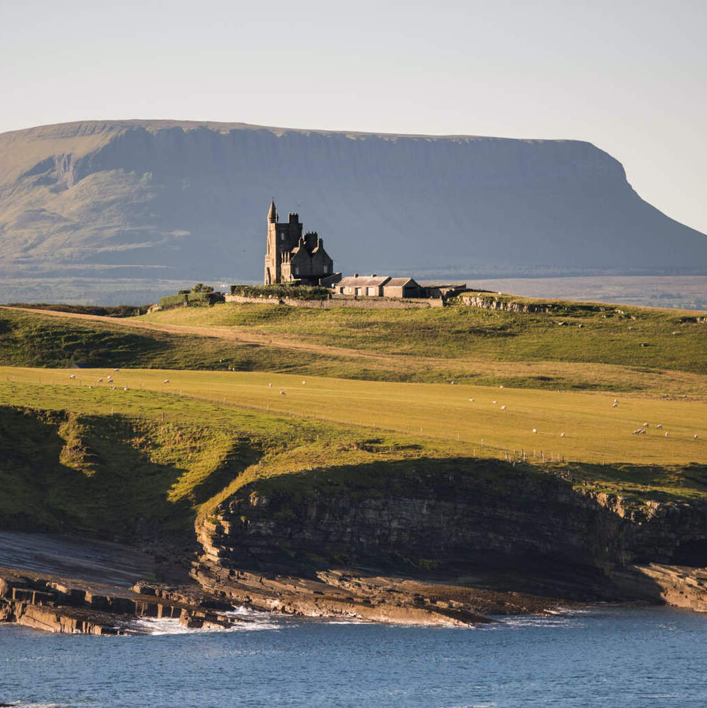Classiebawn Castle on the Mullaghmore Peninsula, with Ben Bulben mountain in the background, County Sligo.