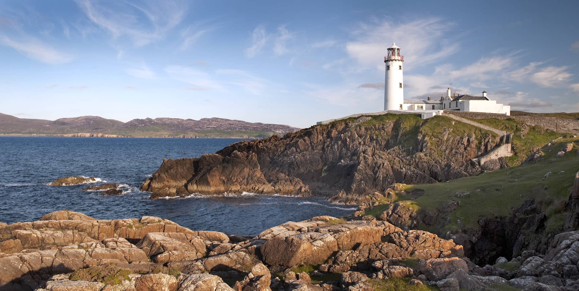 Fanad Head Lighthouse standing on rugged cliffs above the Atlantic in County Donegal, Ireland.