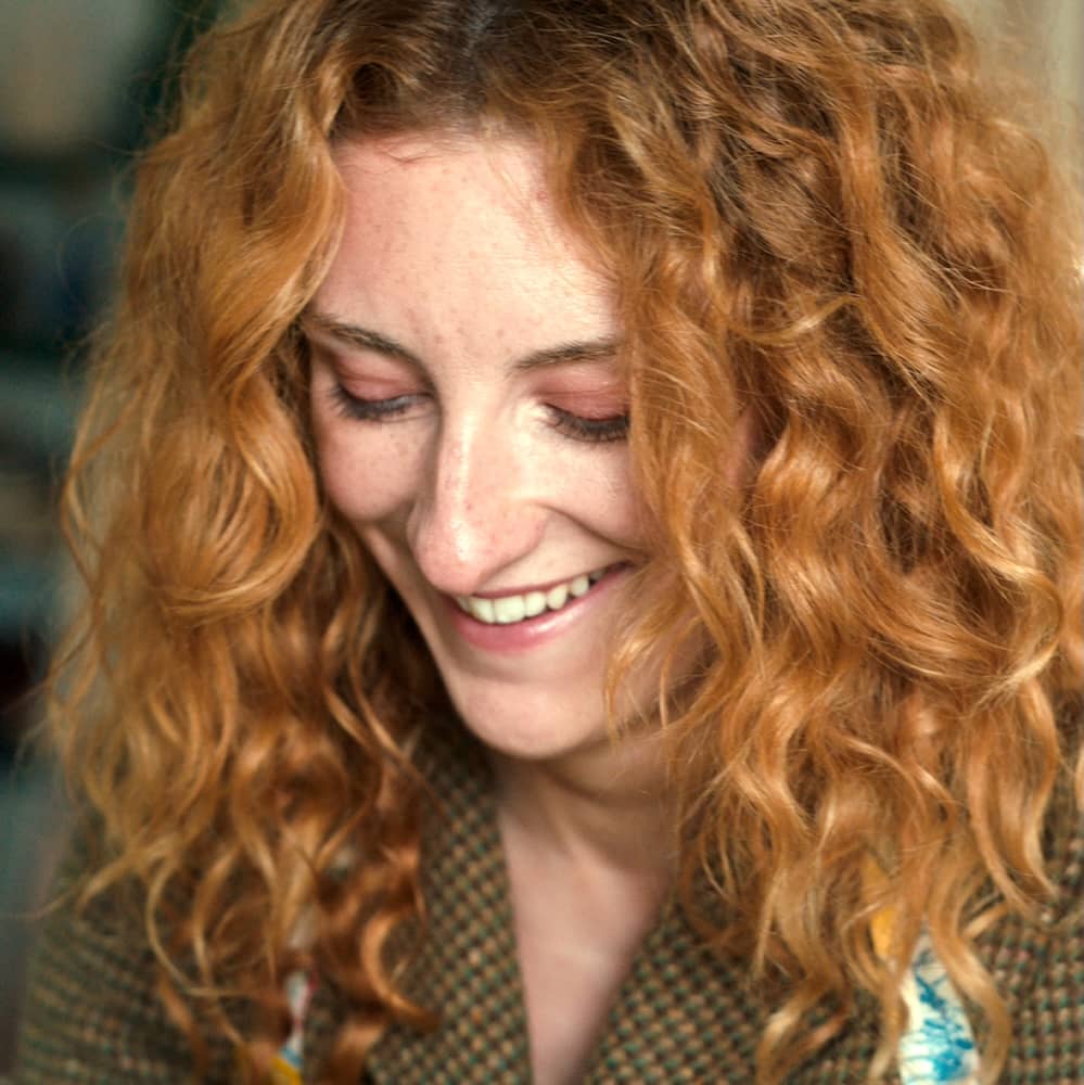 Close-up portrait of a smiling red-haired woman in County Kerry.