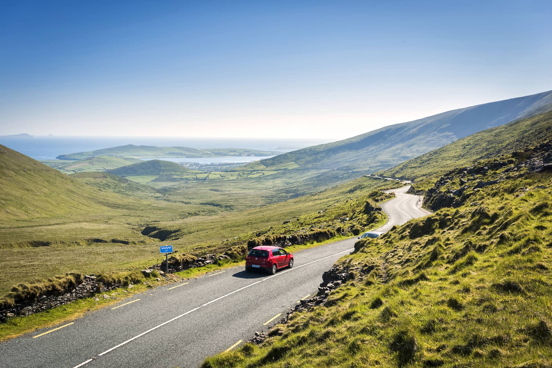 Scenic drive through Conor Pass overlooking mountains and the Atlantic coast in County Kerry.