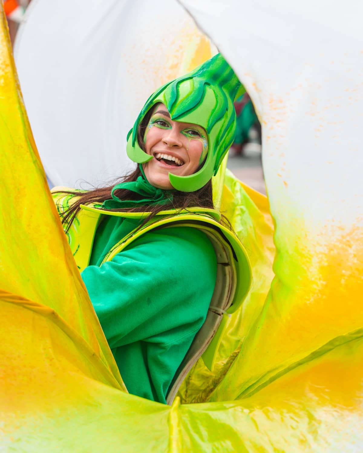 Person in bright green costume celebrating St Patrick’s Day at a festival in Limerick city.