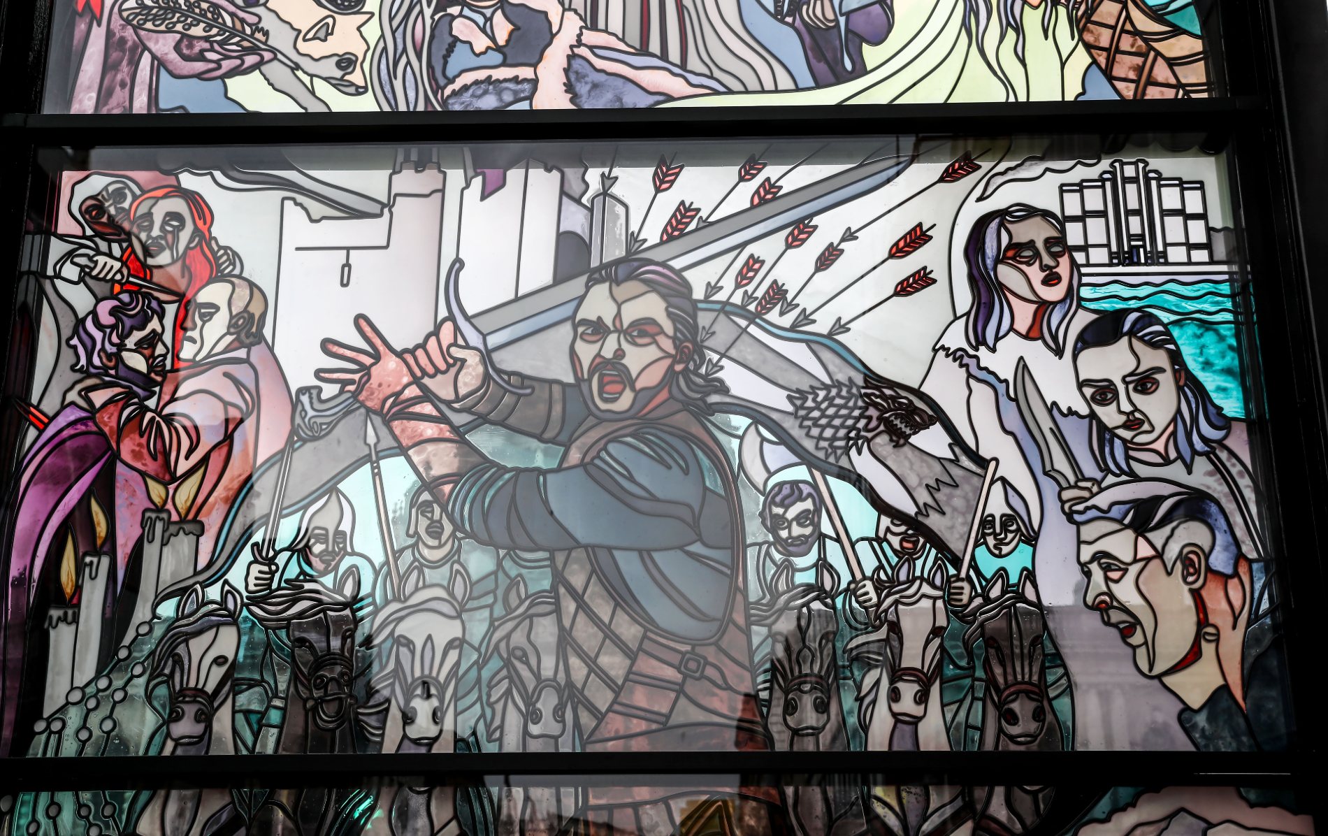 Glas-in-loodramen in City Quays met Jon Snow, het Stark-wapen, Arya, Sansa en levendige beelden van de gevechten uit de serie.