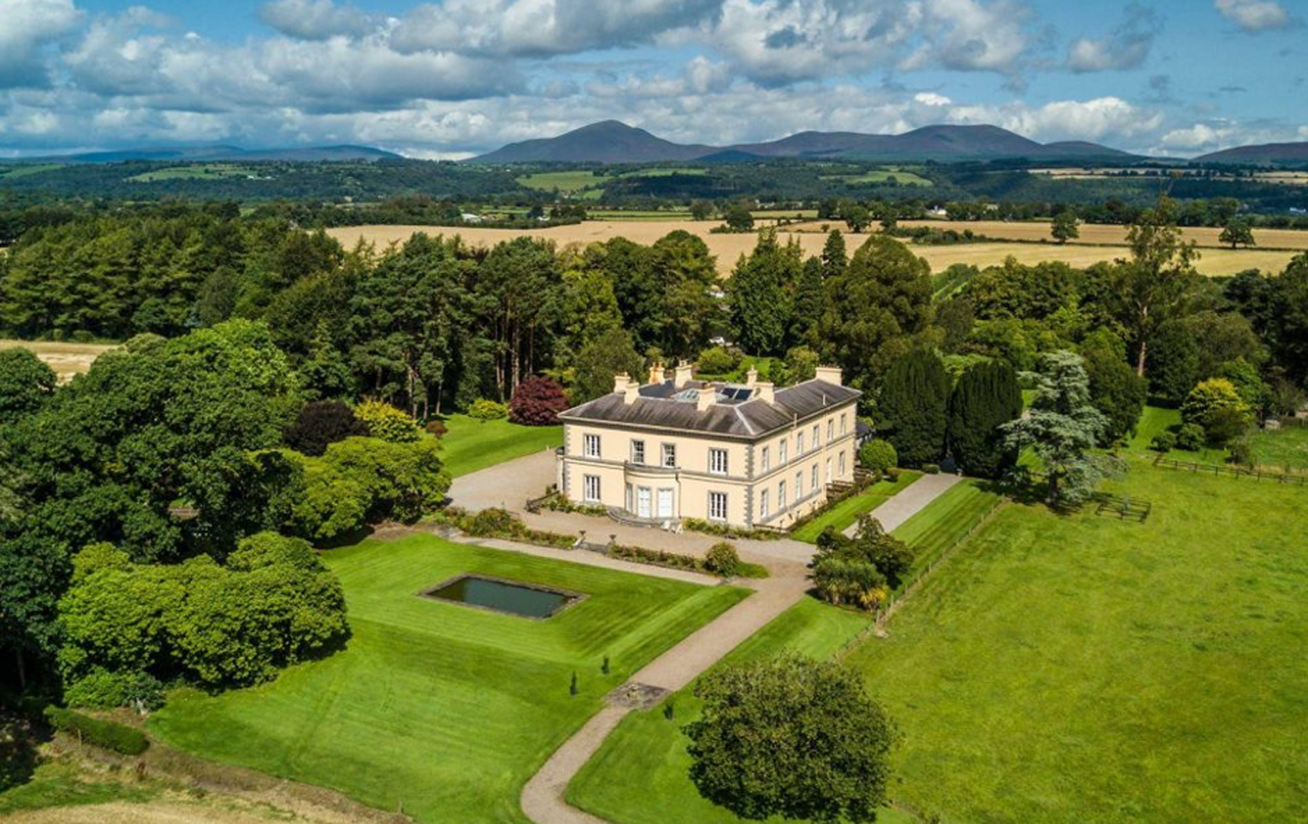 Aerial view of Tourin House, a Georgian country house surrounded by lush gardens in County Waterford.