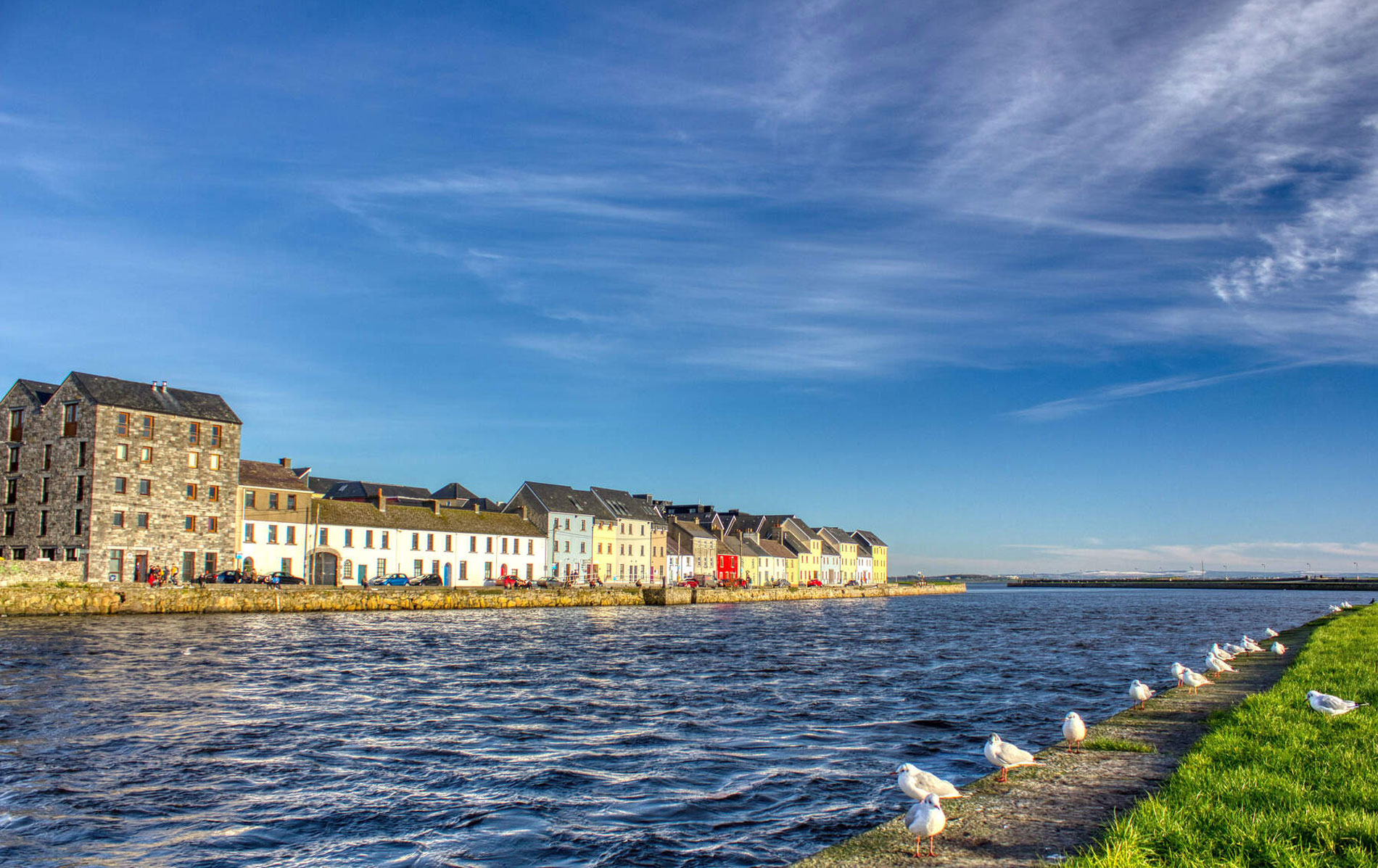 Colourful houses along Galway’s Long Walk beside the River Corrib waterfront.
