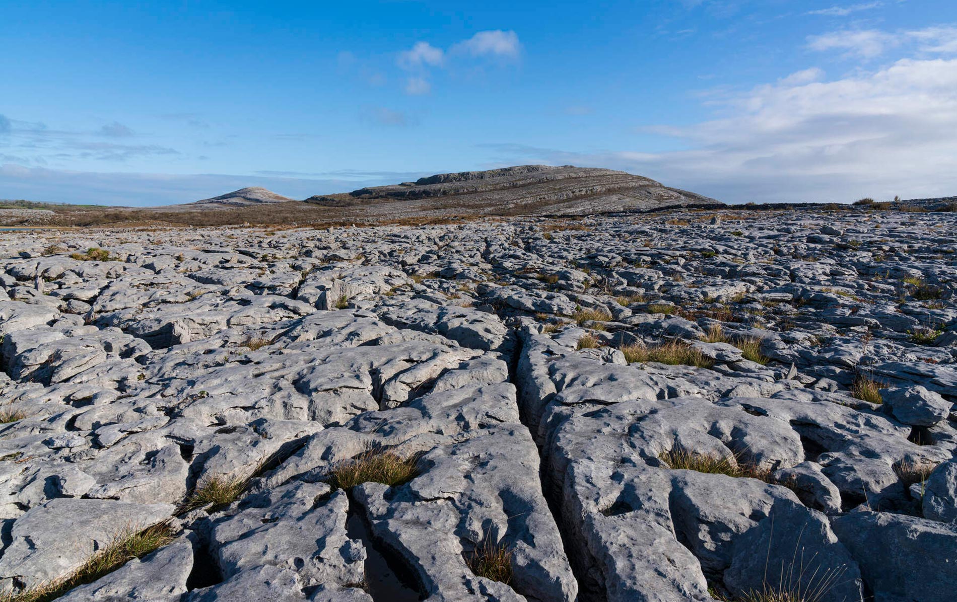 Karst limestone landscape of the Burren in County Clare, under clear skies.