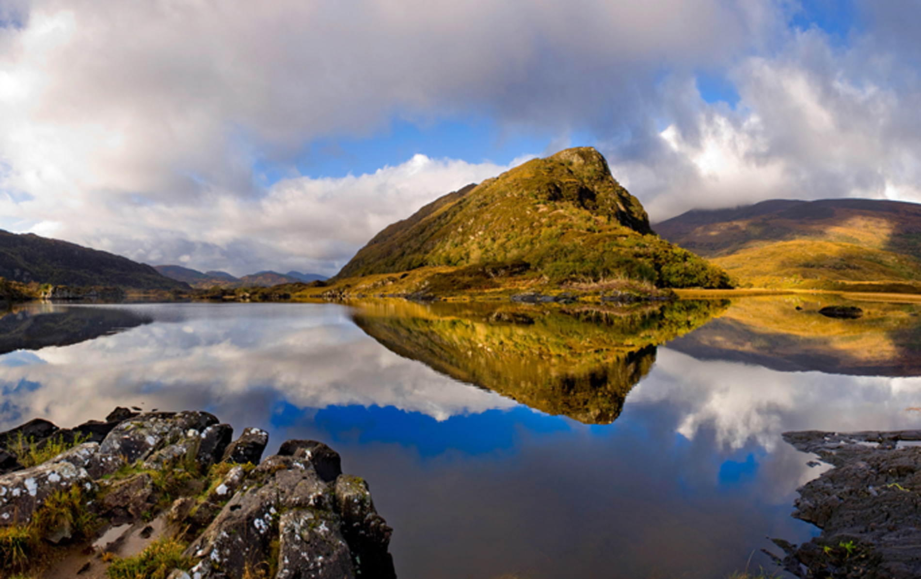 Scenic reflection of mountains and sky on still waters in Killarney National Park, Kerry.
