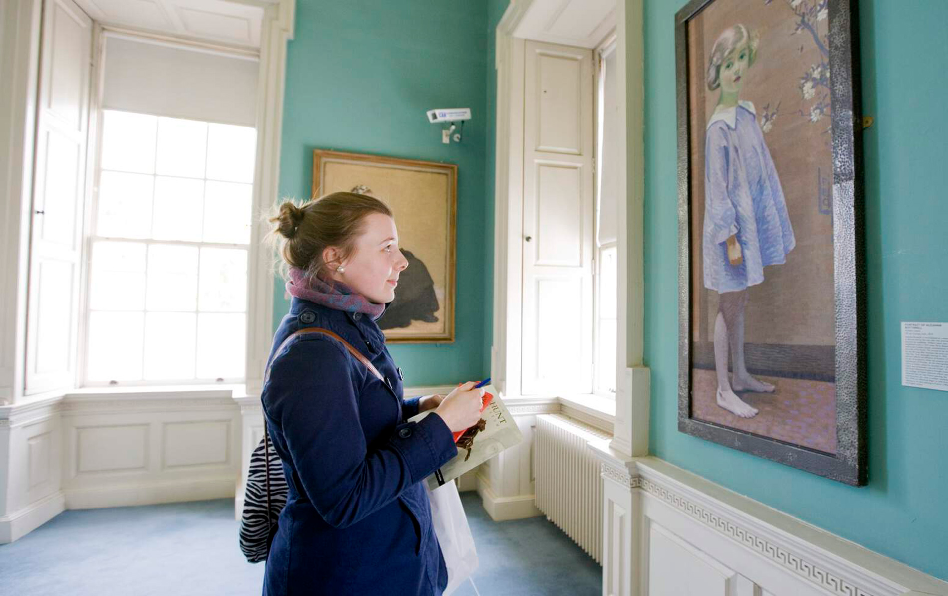 Visitor admiring artwork in the historic Hunt Museum in Limerick city.