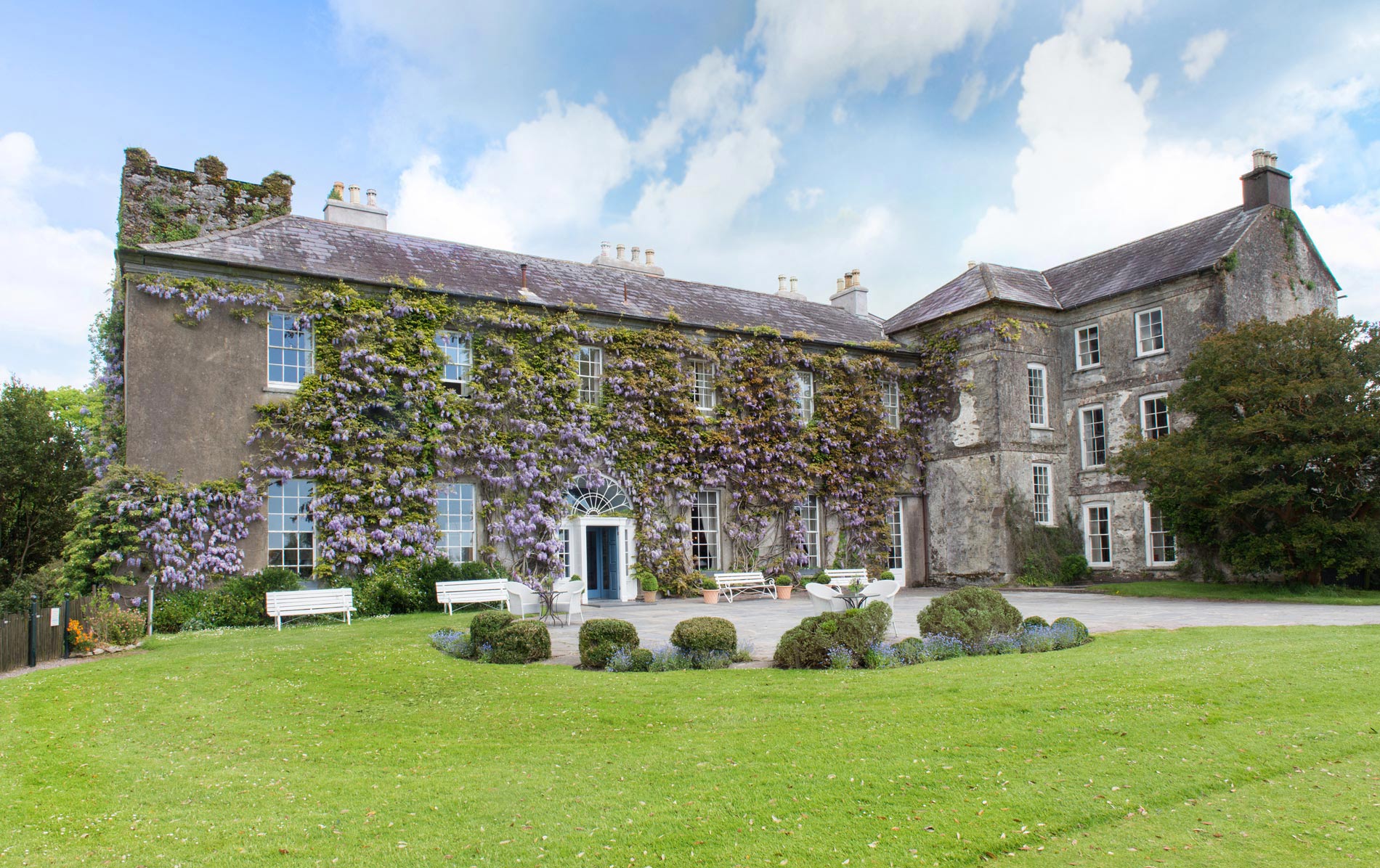 Historic Irish country house, Ballymaloe House in County Cork, with ivy-covered walls and manicured front lawn.