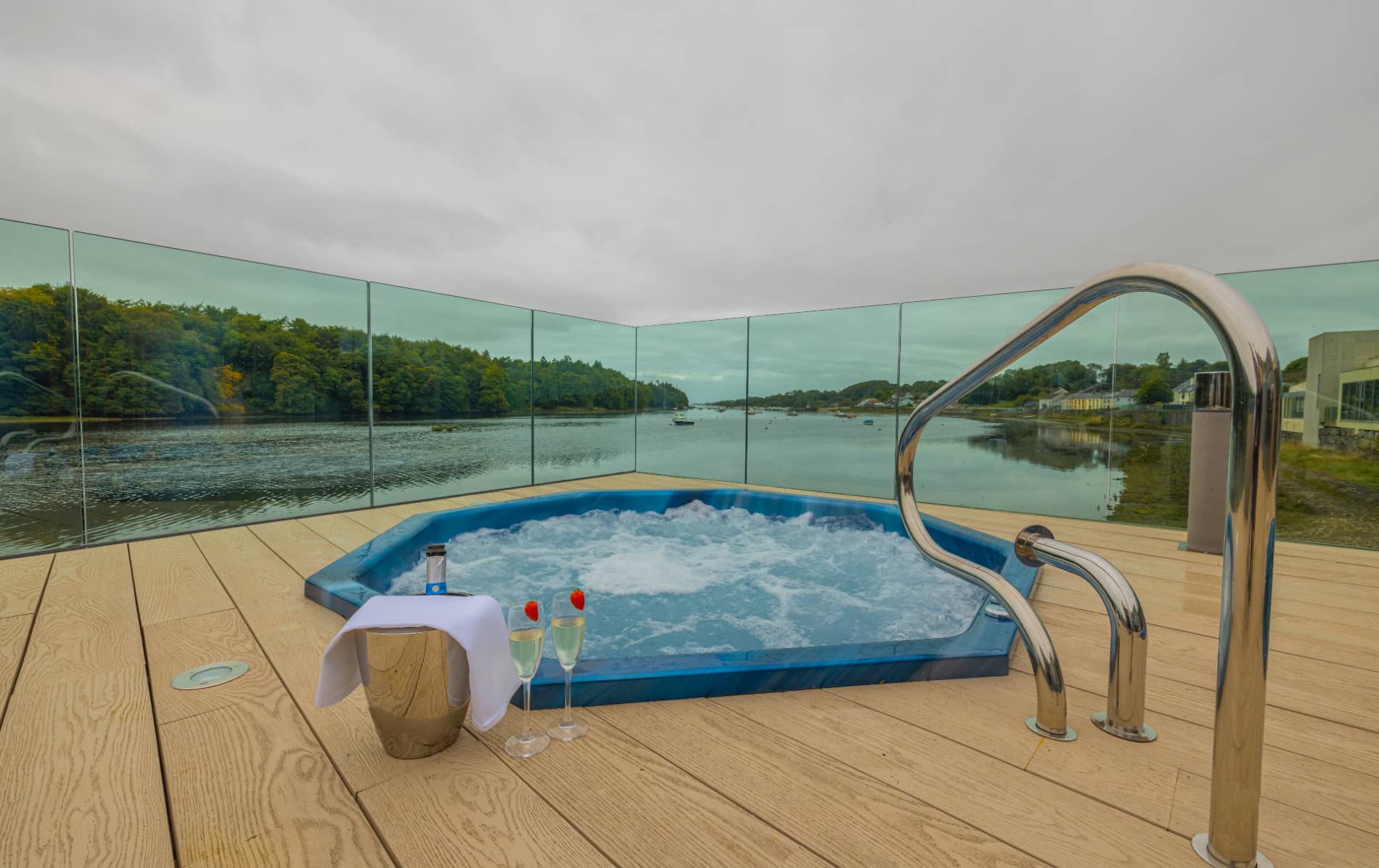 Ice House Hotel hot tub with champagne flutes and views over the River Ilen and woodland in County Mayo.