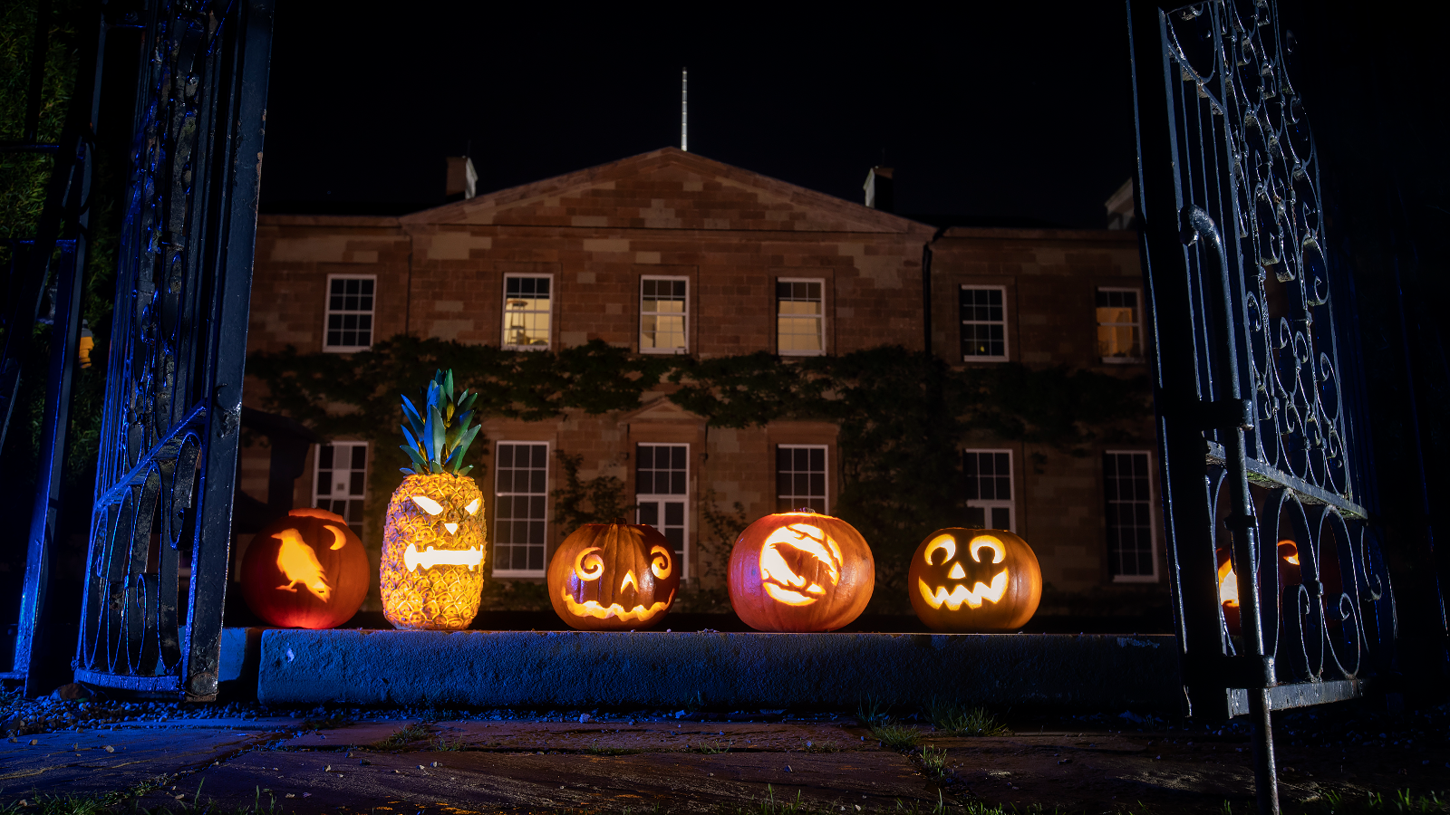Carved Halloween pumpkins outside Hillsborough Castle at night in Royal Hillsborough, County Down.