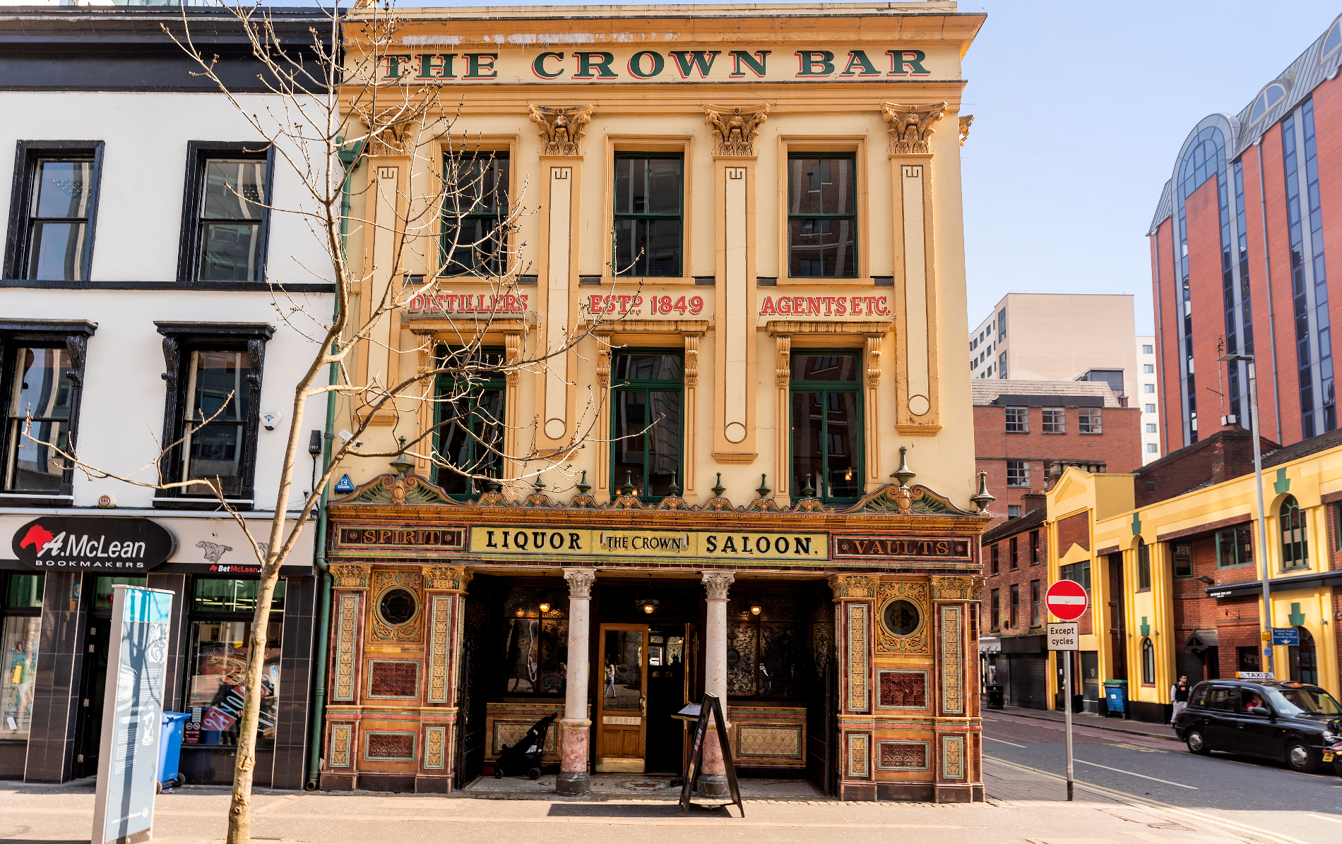 The Crown Liquor Saloon in Belfast, featuring its ornate Victorian façade and decorative tiled entrance.