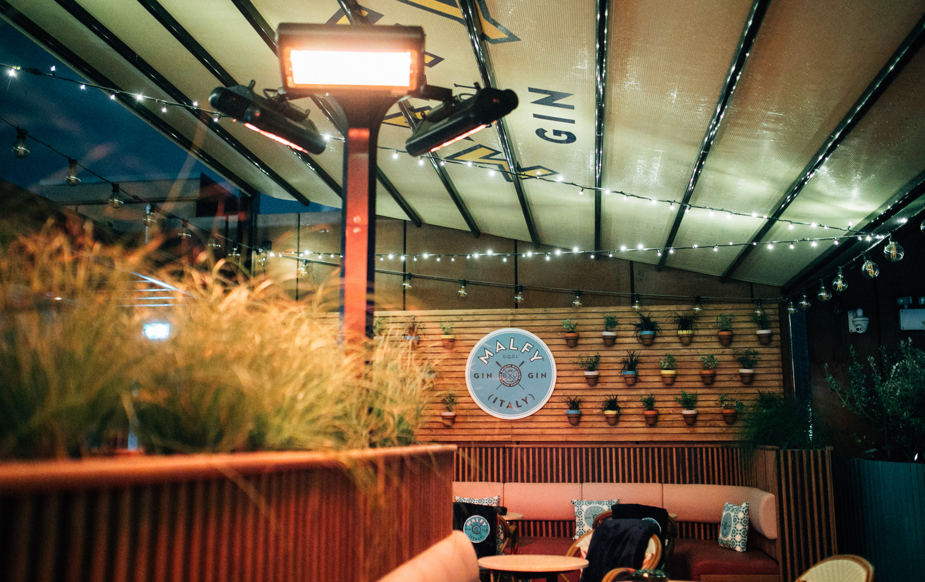 Tetto rooftop bar in Belfast, with covered seating, string lights and a Malfy Gin display.