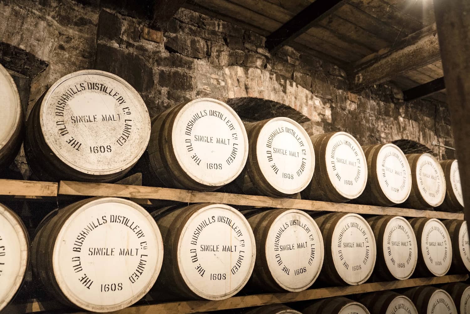 Rows of whiskey barrels ageing inside the Old Bushmills Distillery, Antrim.