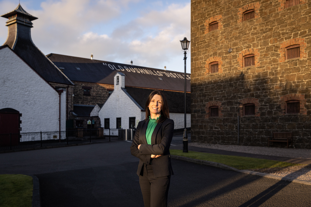 Staff member standing in the courtyard at Old Bushmills Distillery, County Antrim.