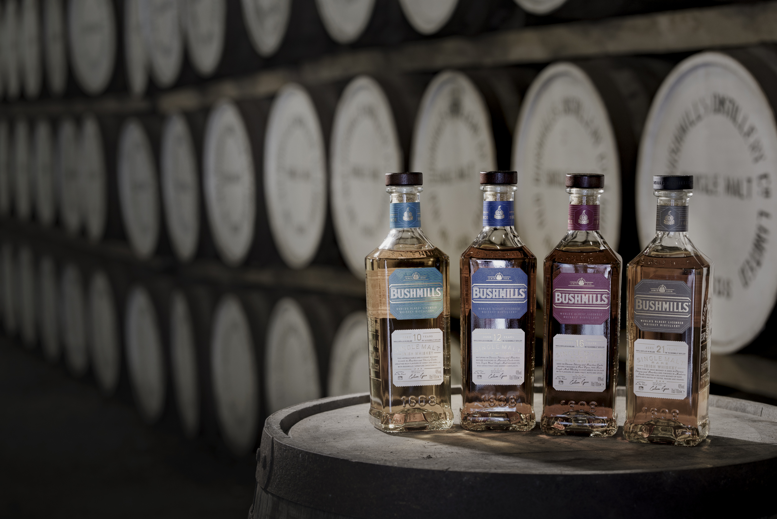 Bushmills whiskey bottles displayed on a barrel inside Bushmills Distillery, County Antrim.