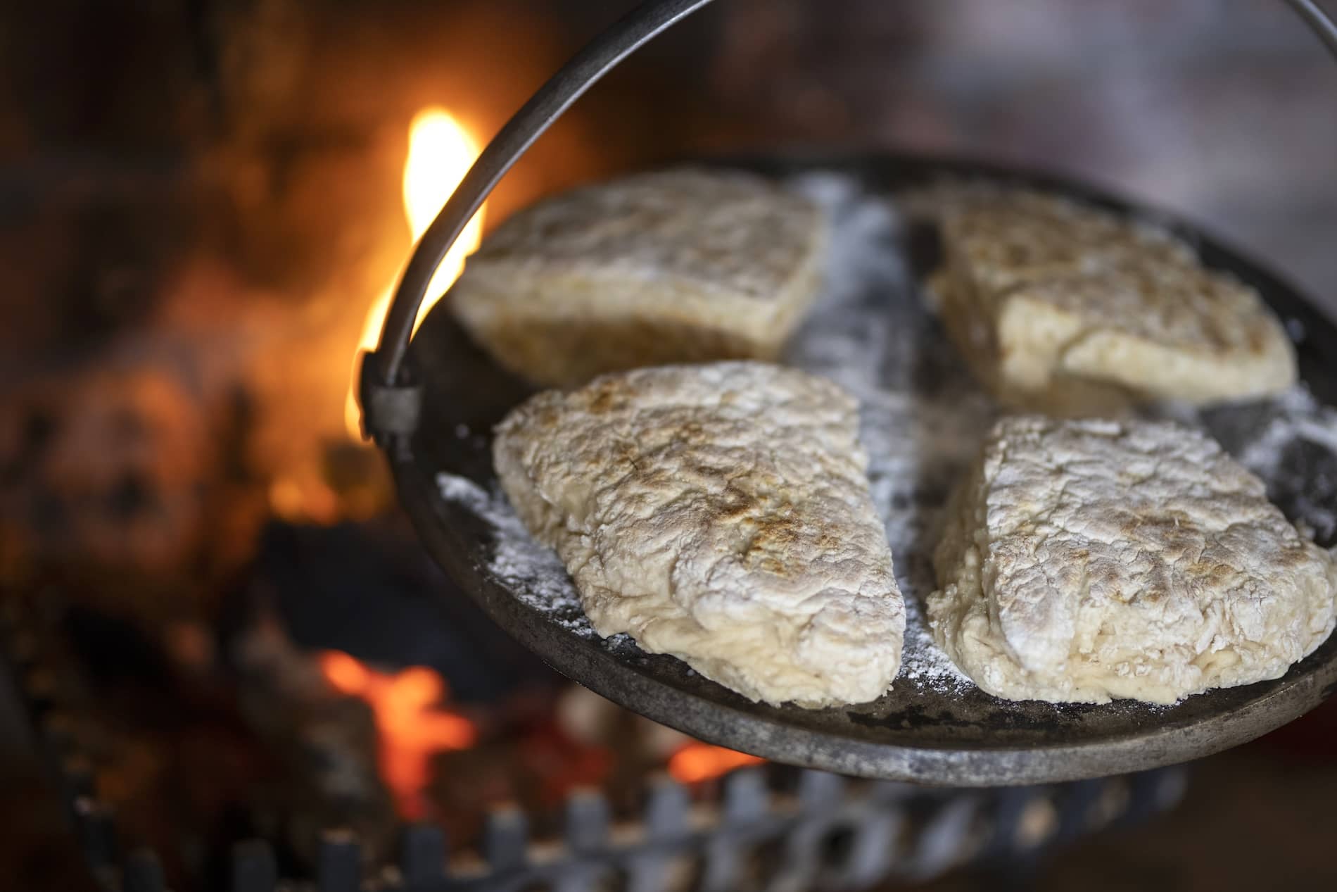 Traditional Northern Irish soda farls cooking on a griddle over an open fire