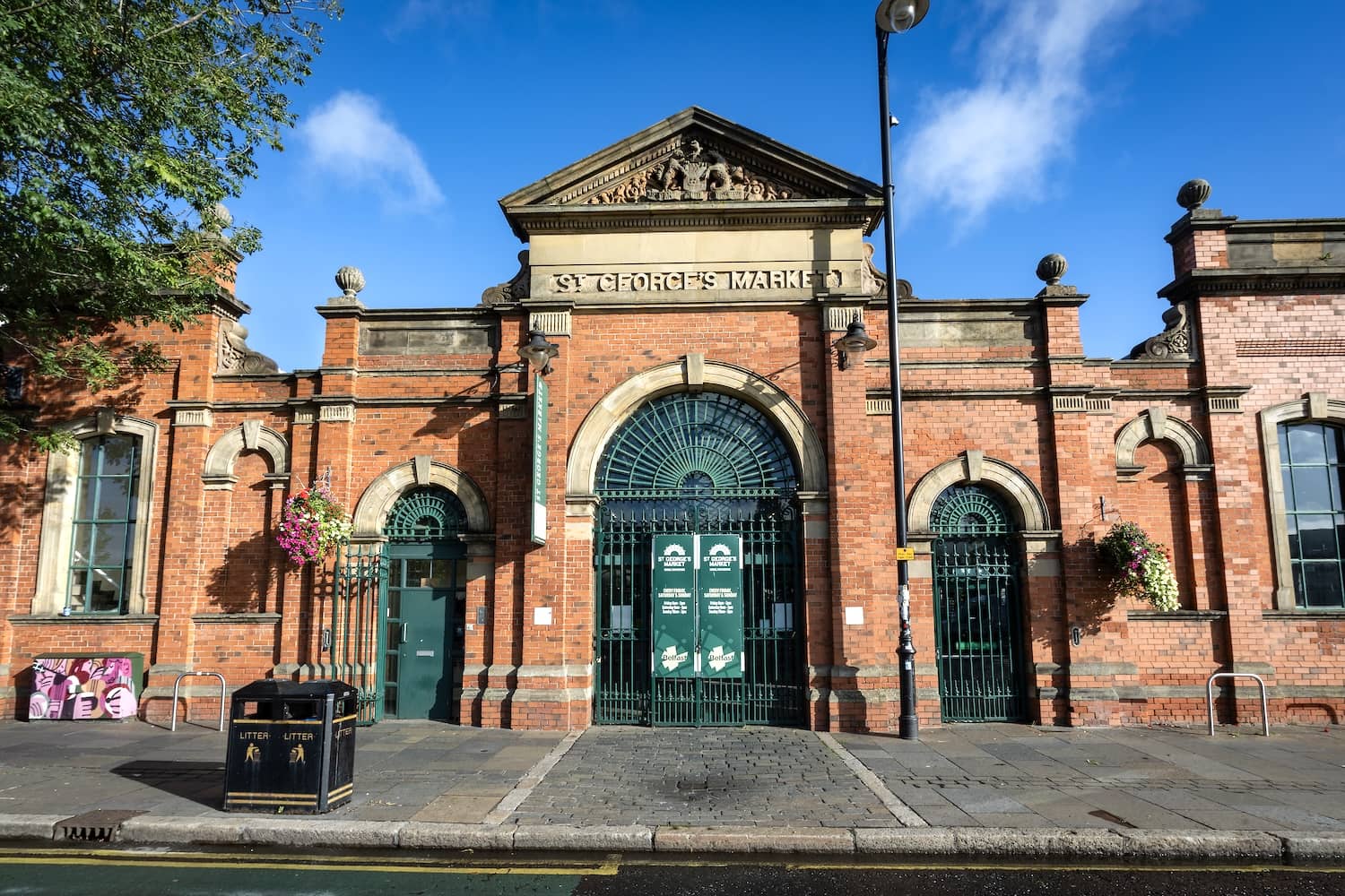 The red-brick façade and arched entrance of St George’s Market in Belfast.