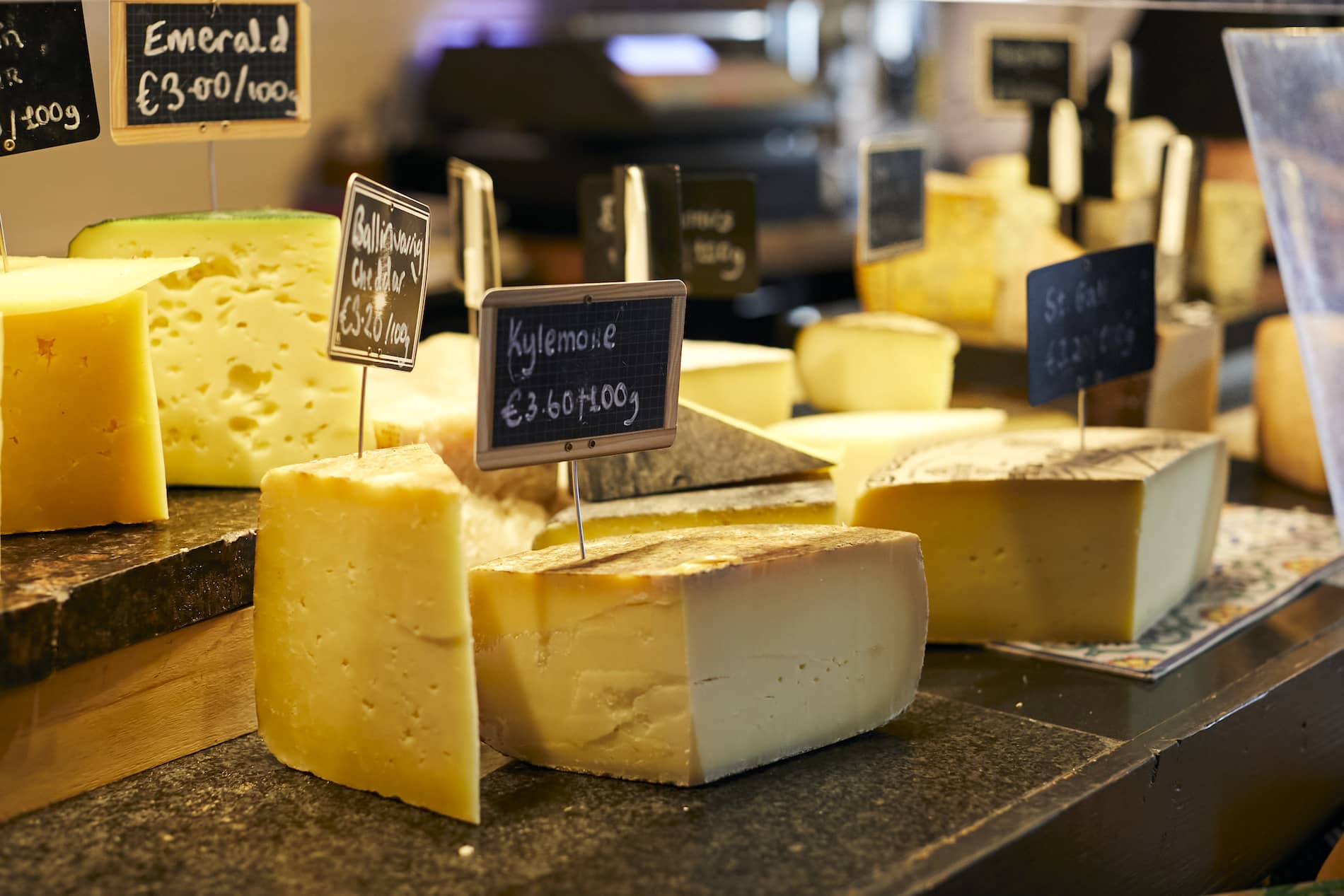 Artisan cheeses, including Kylemore and Ballinwillin, displayed at a food market in Dingle, Kerry.