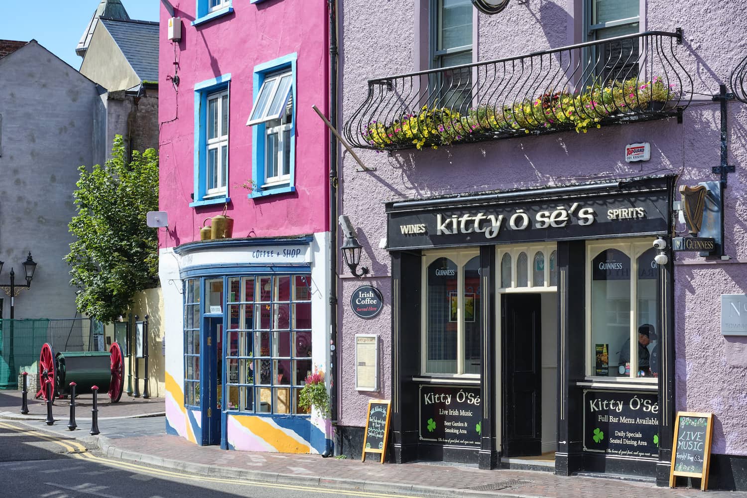 Colourful shopfronts on a street in Kinsale, County Cork, including Kitty O’Sé’s pub.