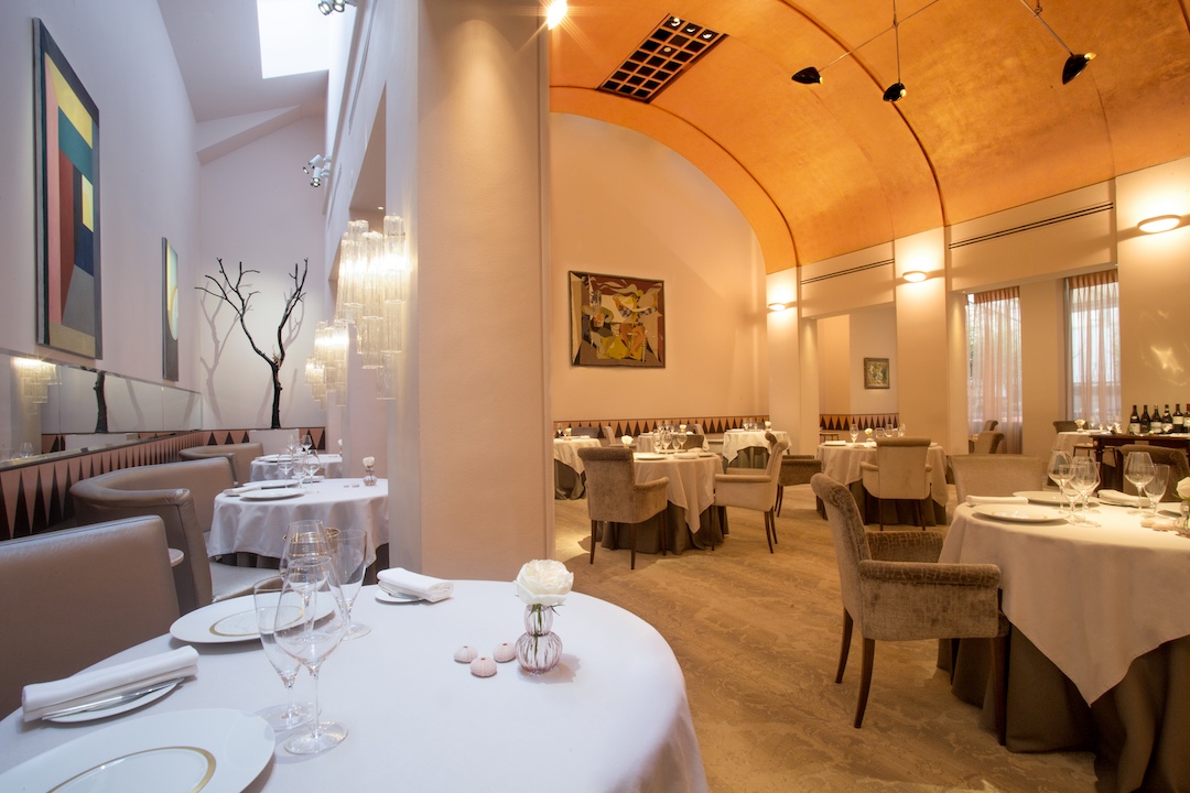 Elegant dining room with arched ceiling and white table settings in Restaurant Patrick Guilbaud, Dublin.