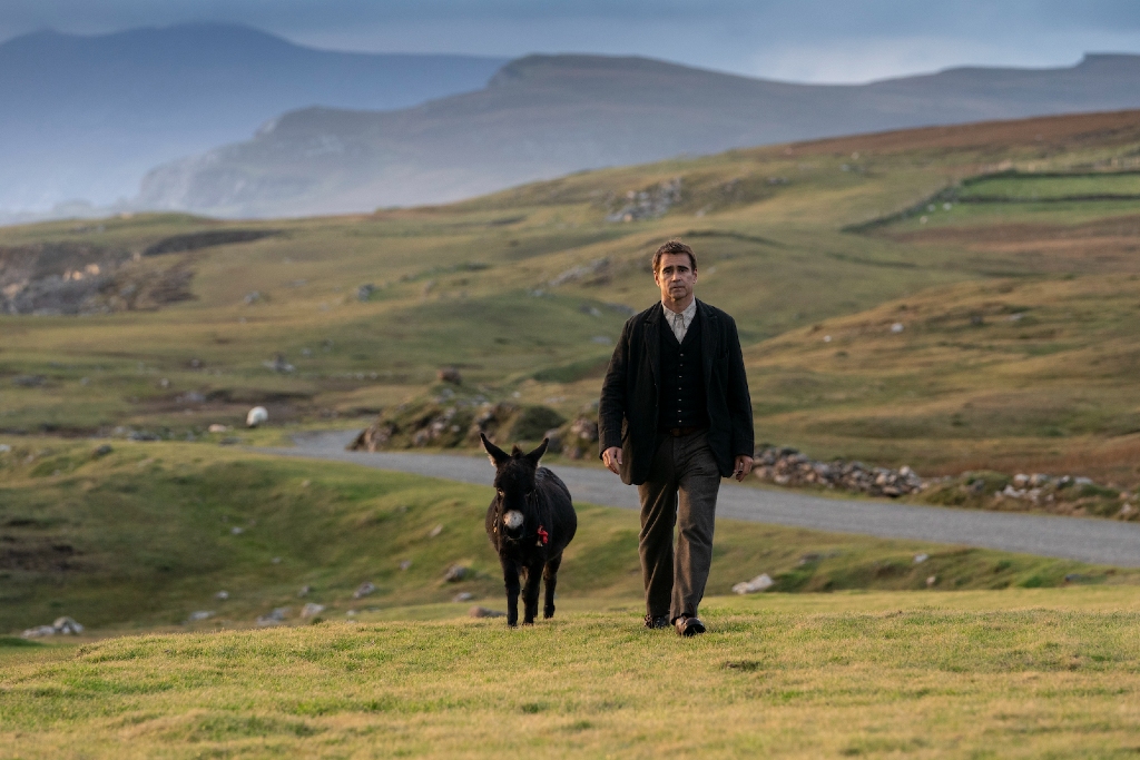 Colin Farrell walking with a small donkey on grassy hills in Achill Island, County Mayo, Ireland.