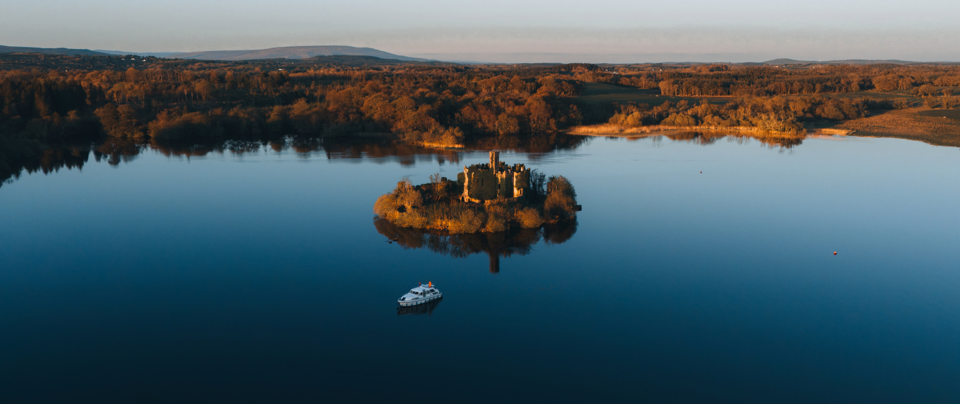 Aerial view of McDermott’s Castle on a small island in Lough Key, County Roscommon, at sunset.