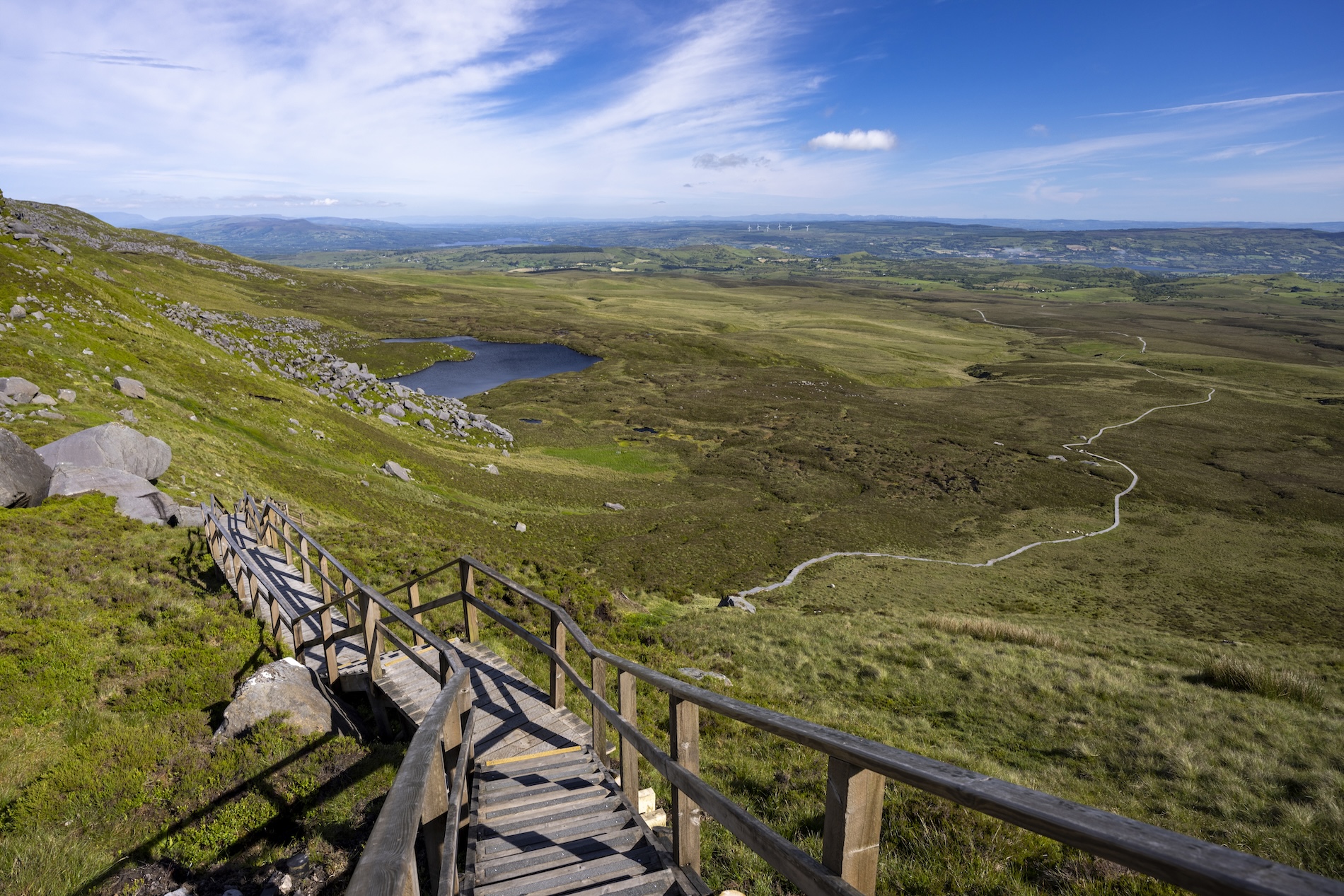 Boardwalk steps on the Cuilcagh Trail leading down toward the bogland and lake in County Fermanagh.